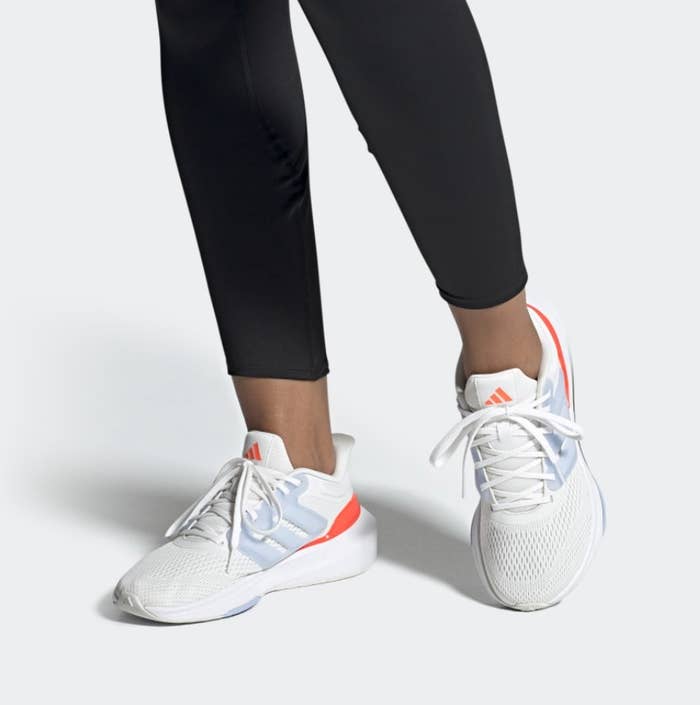 A white with orange detailing running shoe