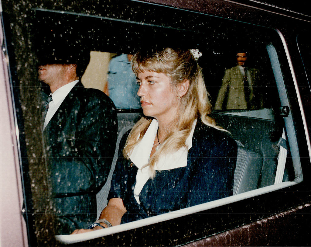 Karla in a car on the way to a trial with long blonde hair