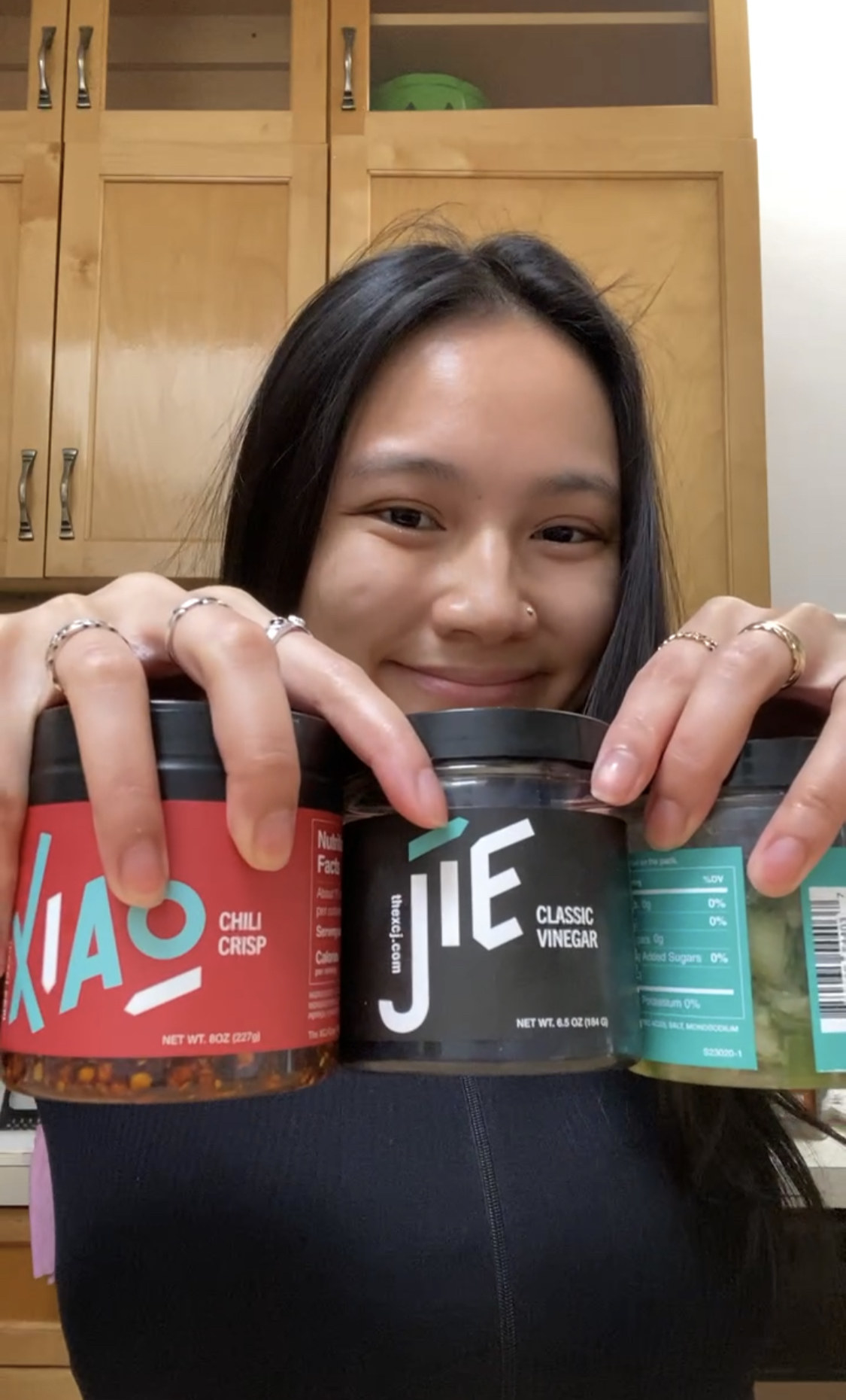 girl holding up three different sauces from mila