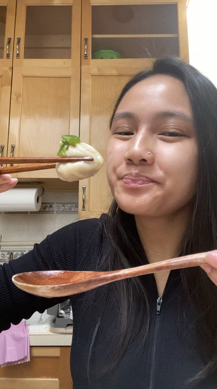 girl about to eat soup dumpling