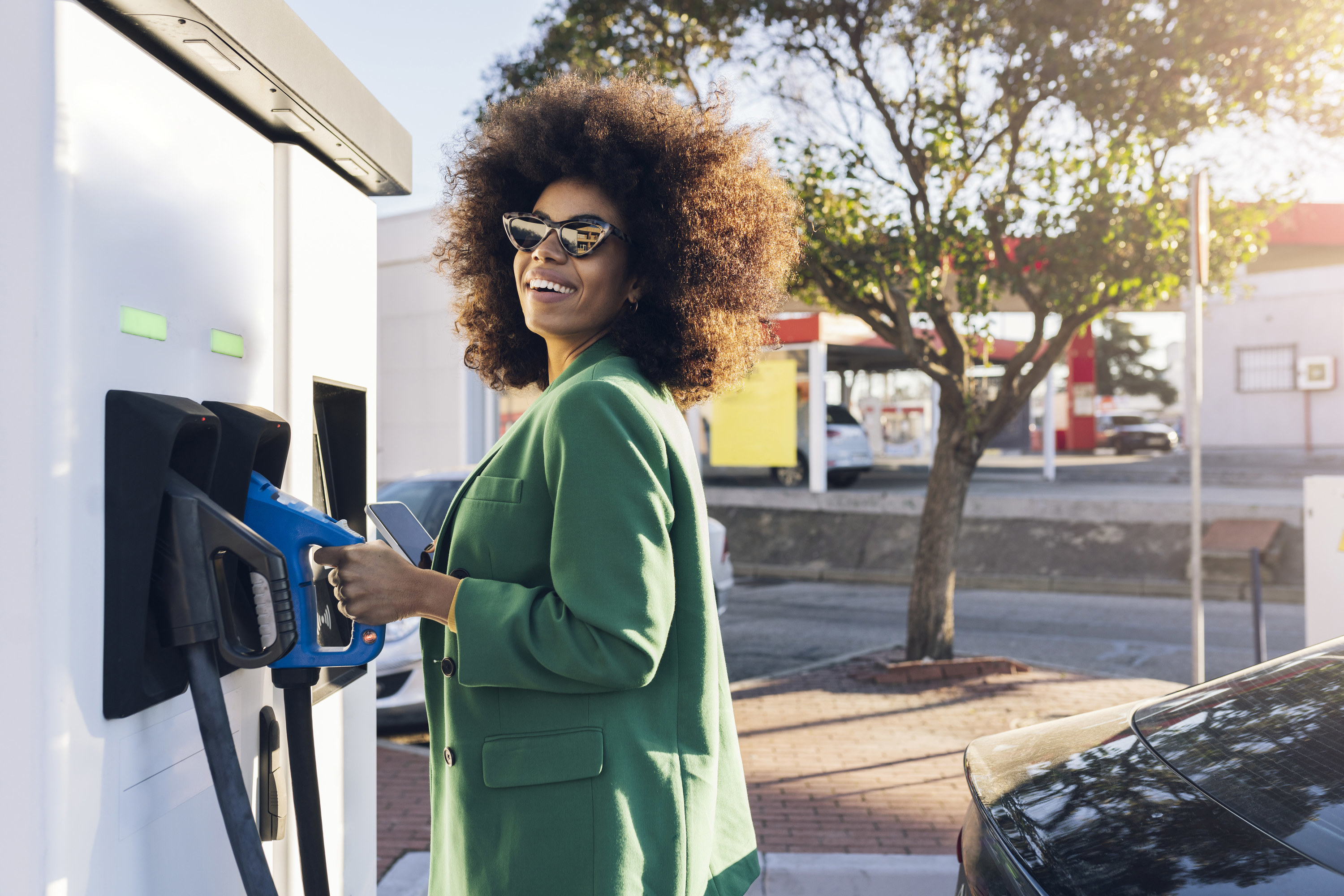 Woman standing at a gas pump