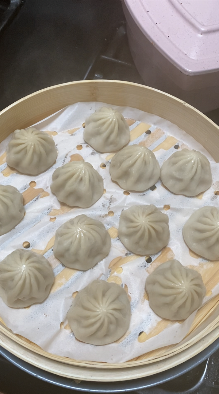 cooked soup dumplings in bamboo steamer