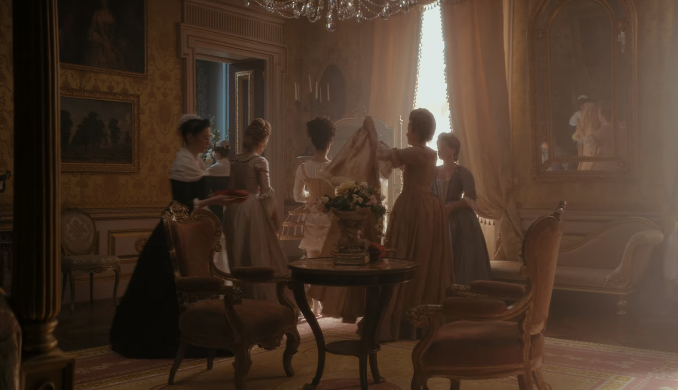 women getting the queen ready and dressed