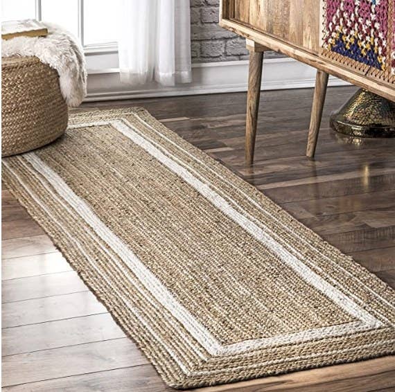 a beige and white braided runner measuring 2&#x27; 6&quot; x 6&#x27;