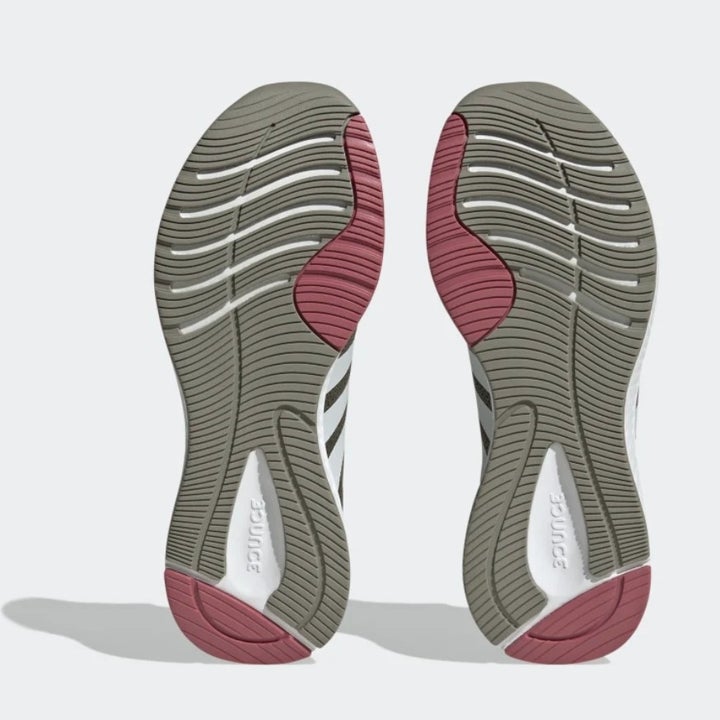 The bottoms of a pair of running shoes