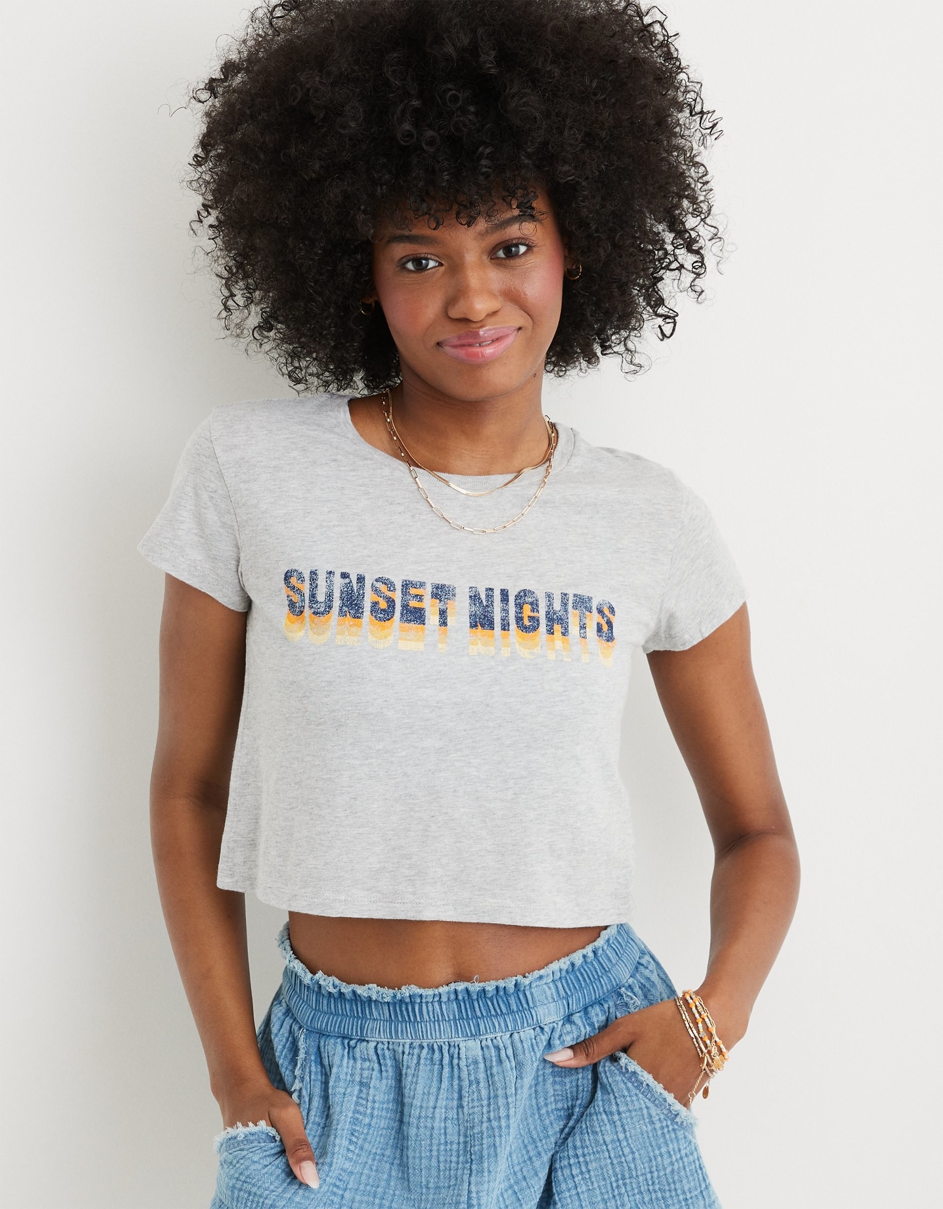 model in grey cropped tee reading &quot;sunset nights&quot;