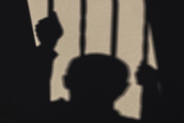 A silhouette of a person in prison