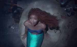 A mermaid sings on a rock
