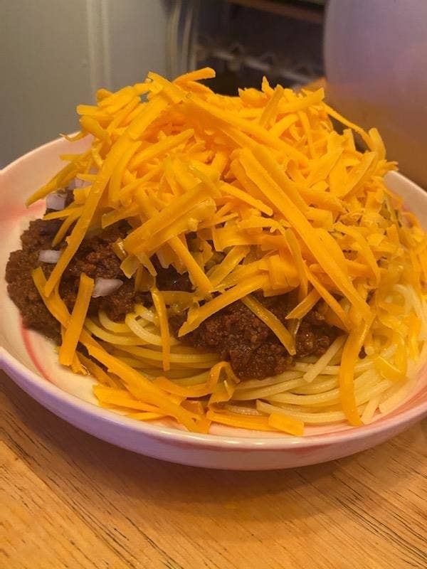 Spaghetti with chili and cheese on top.