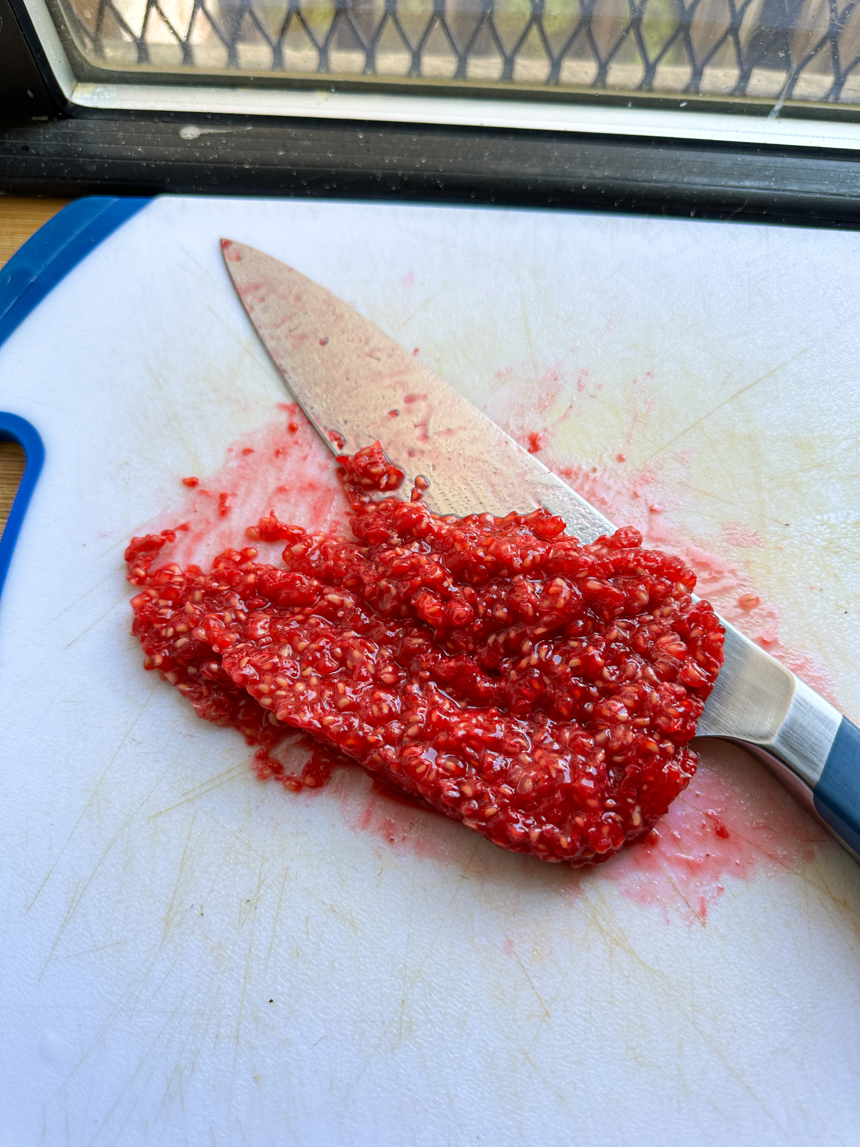 finely chopped fresh raspberries on a cutting board