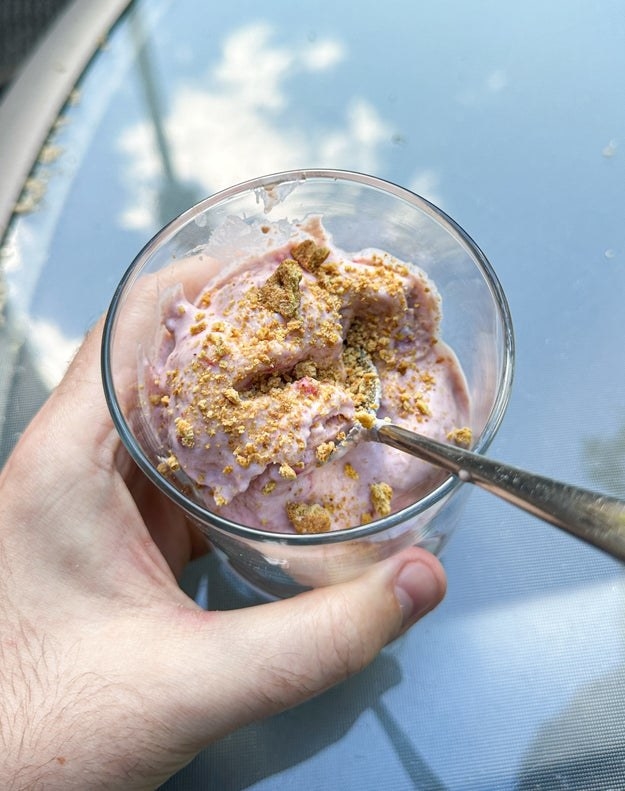 pink-hued cottage cheese ice cream in a glass cup, topped with graham cracker crumbs