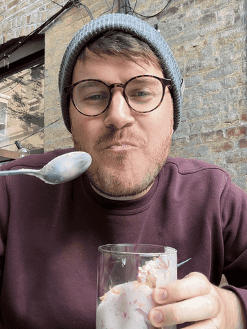 GIF of author eating the ice cream and smiling
