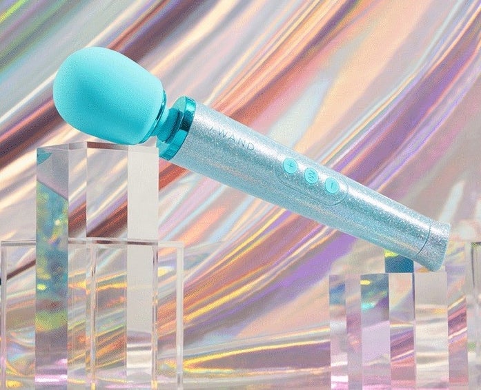 Light blue glitter wand vibrator on display