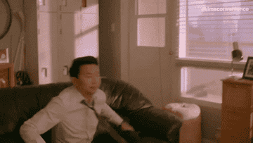 Simu Liu kicks his feet up on an episode of Kim's Convenience