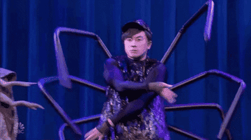 Gif of a person dressed as a spider dancing