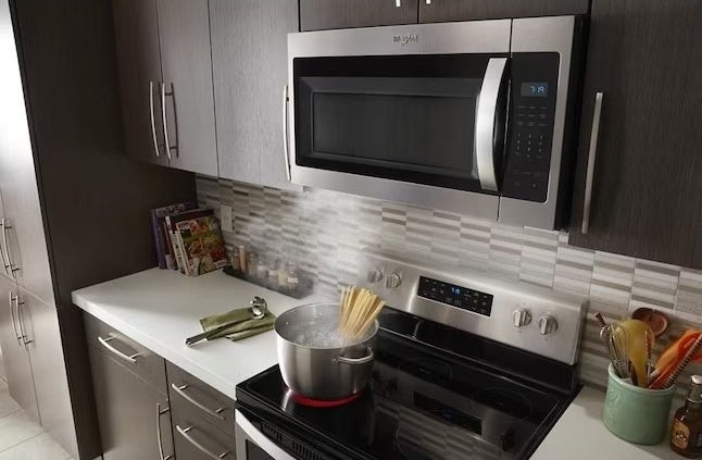 a stainless steel microwave above a stainless steel oven