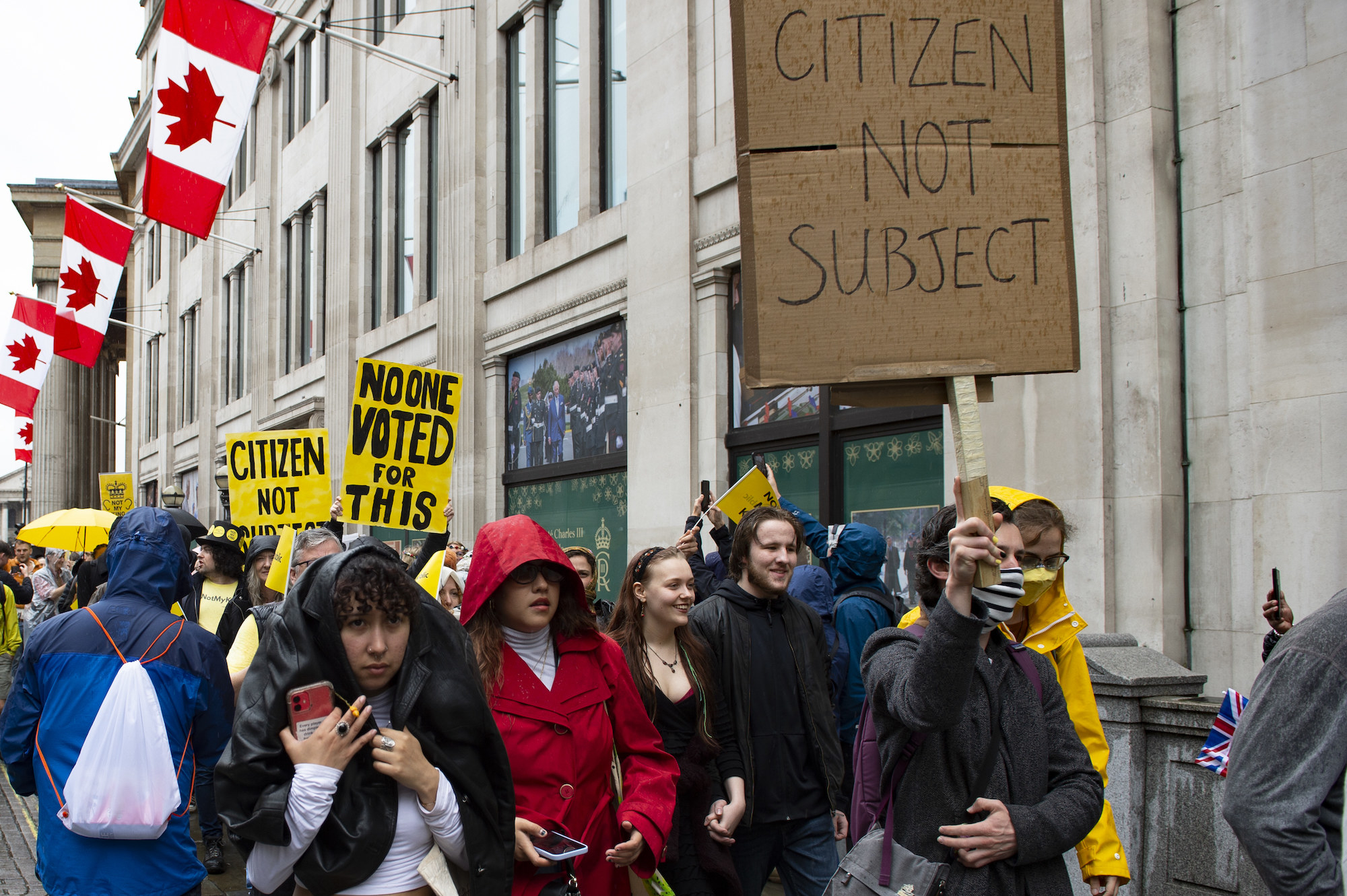 crowd carrying signs, no one voted for this and citizen not subject
