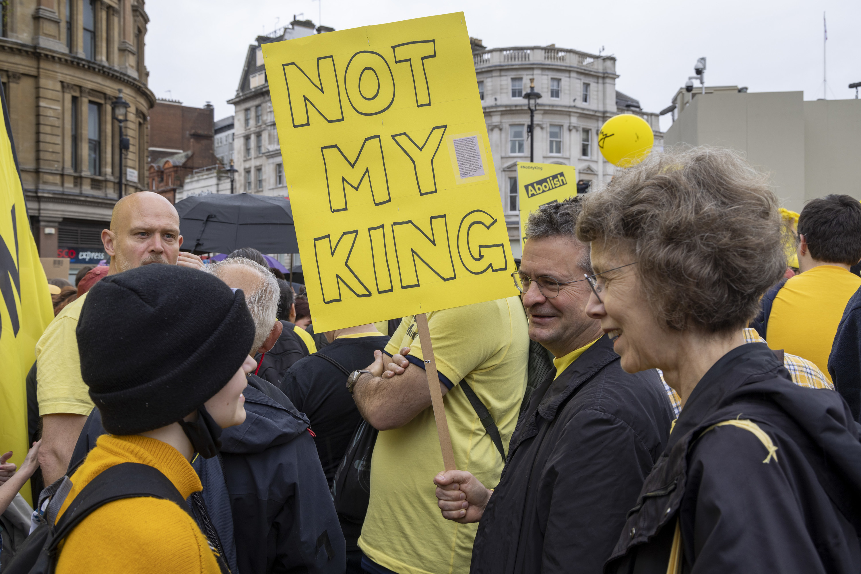 crowd with not my king signs