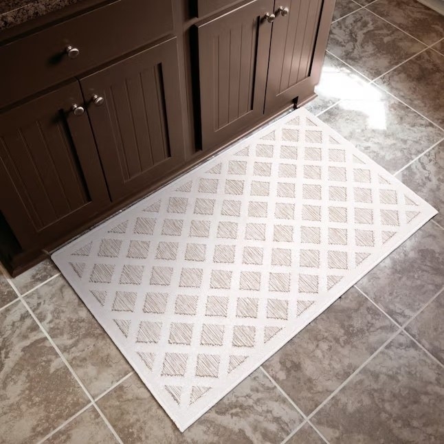 a white and cream runner rug with a diamond pattern