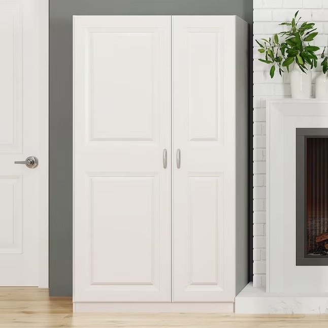a white floor cabinet next to a door and fire place