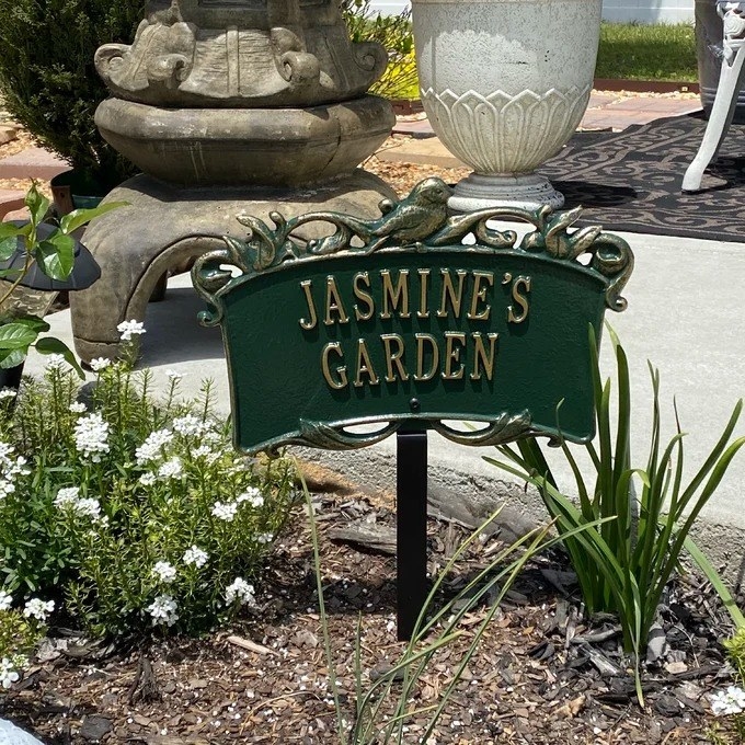 A reviewer photo of the personalized garden sign that reads &quot;Jasmine&#x27;s Garden&quot;
