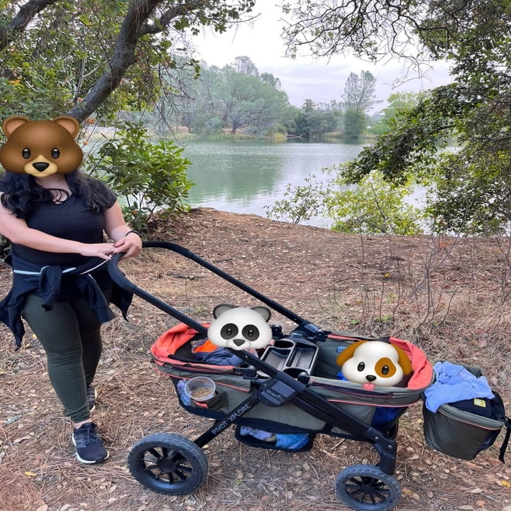 Reviewer on nature walk with two kids in the stroller wagon with hooded side shields folded down