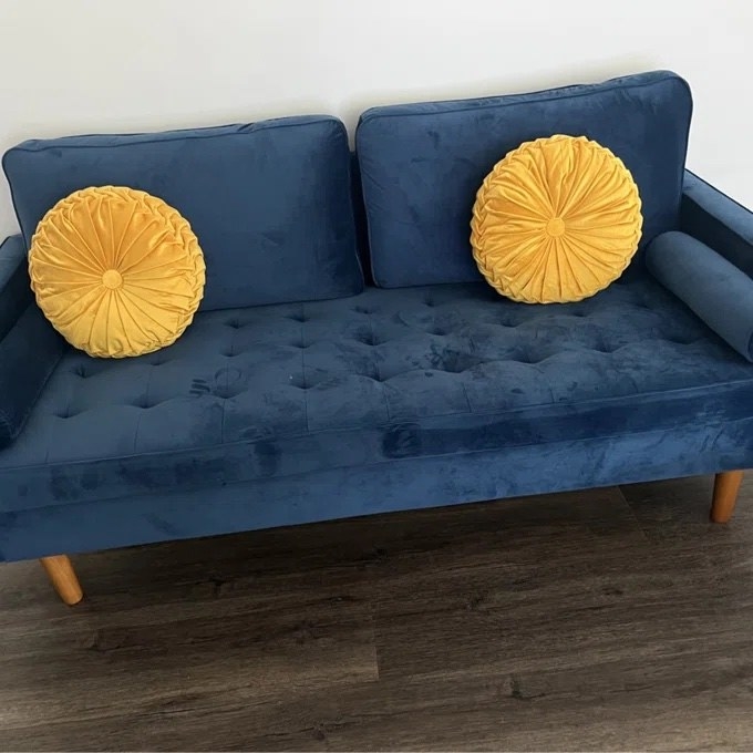 the pillows in yellow on a blue couch