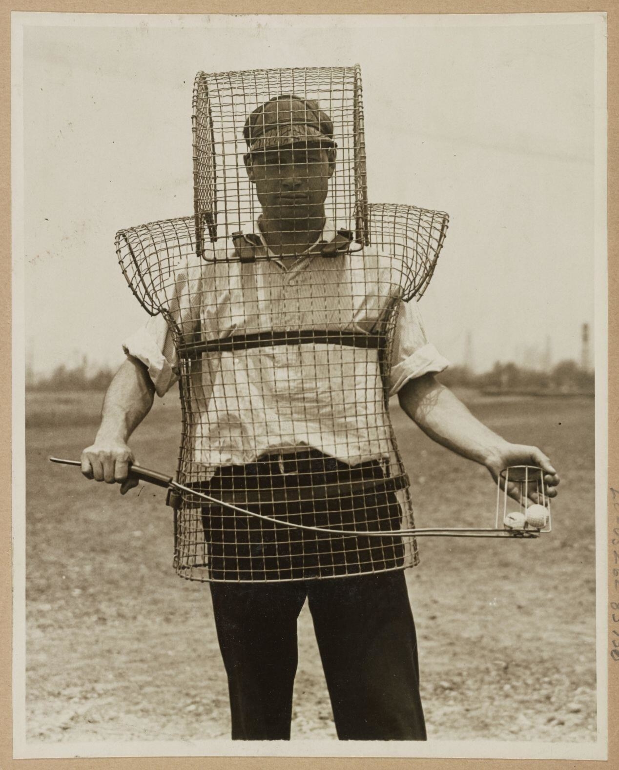 A man wearing armor while retrieving golf balls