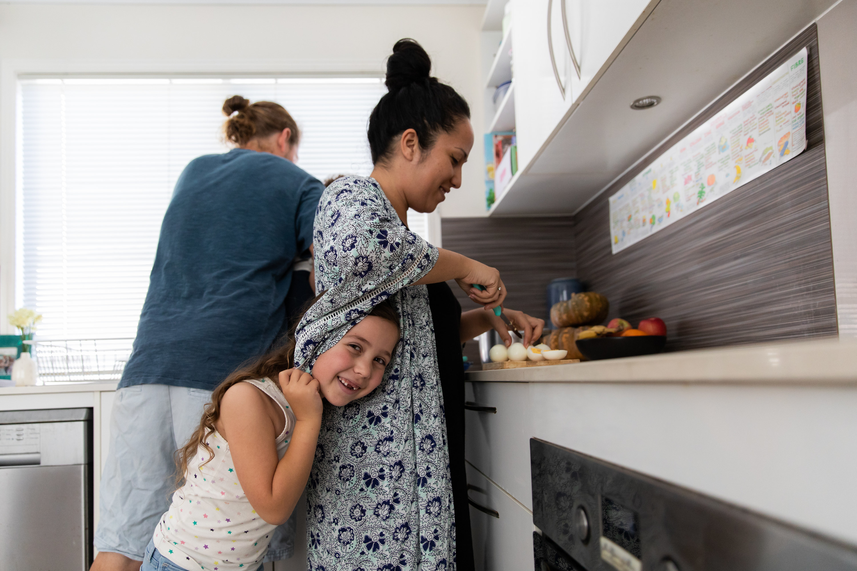 a couple making breakfast with a little kid