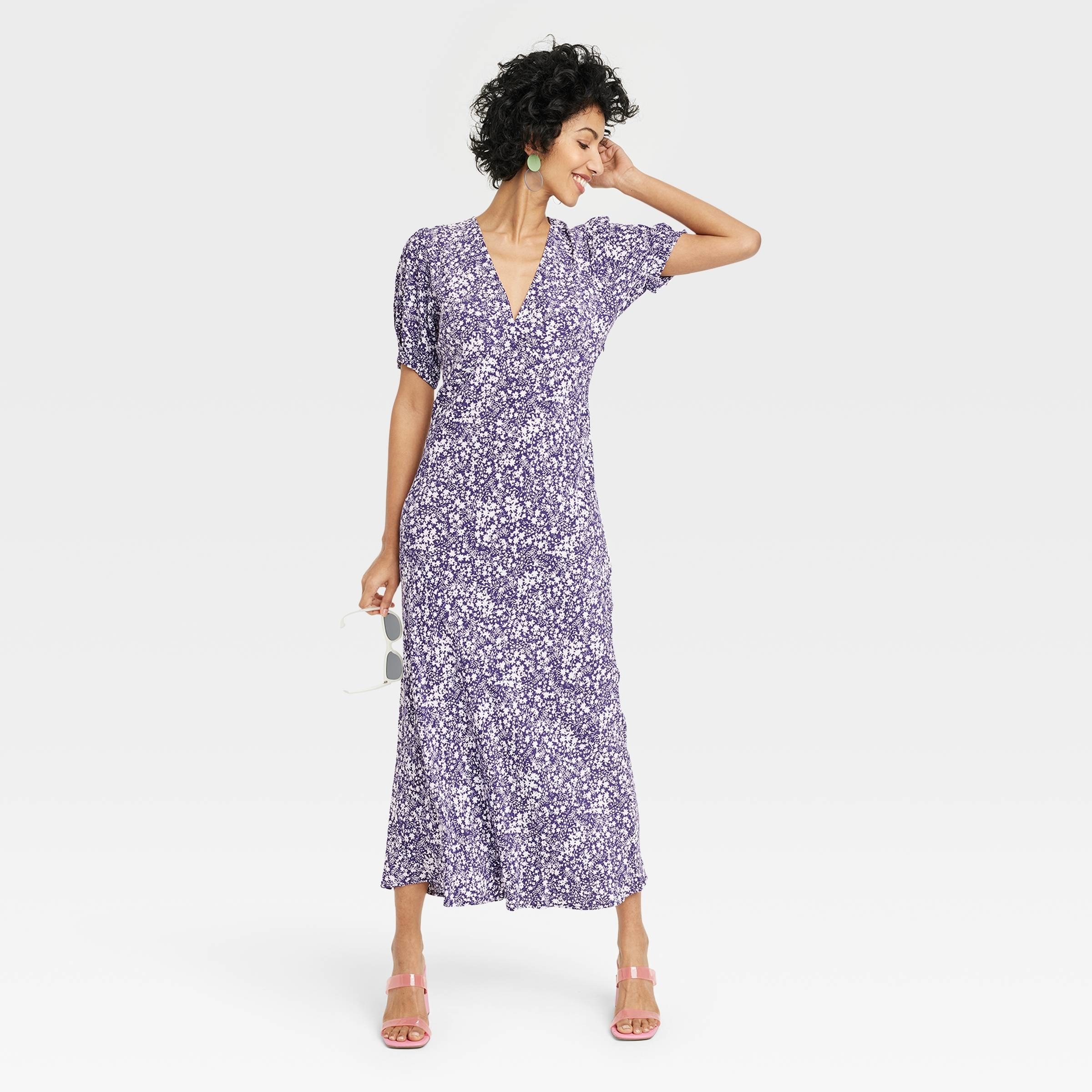 A model wearing the ditsy floral-print midi-length dress