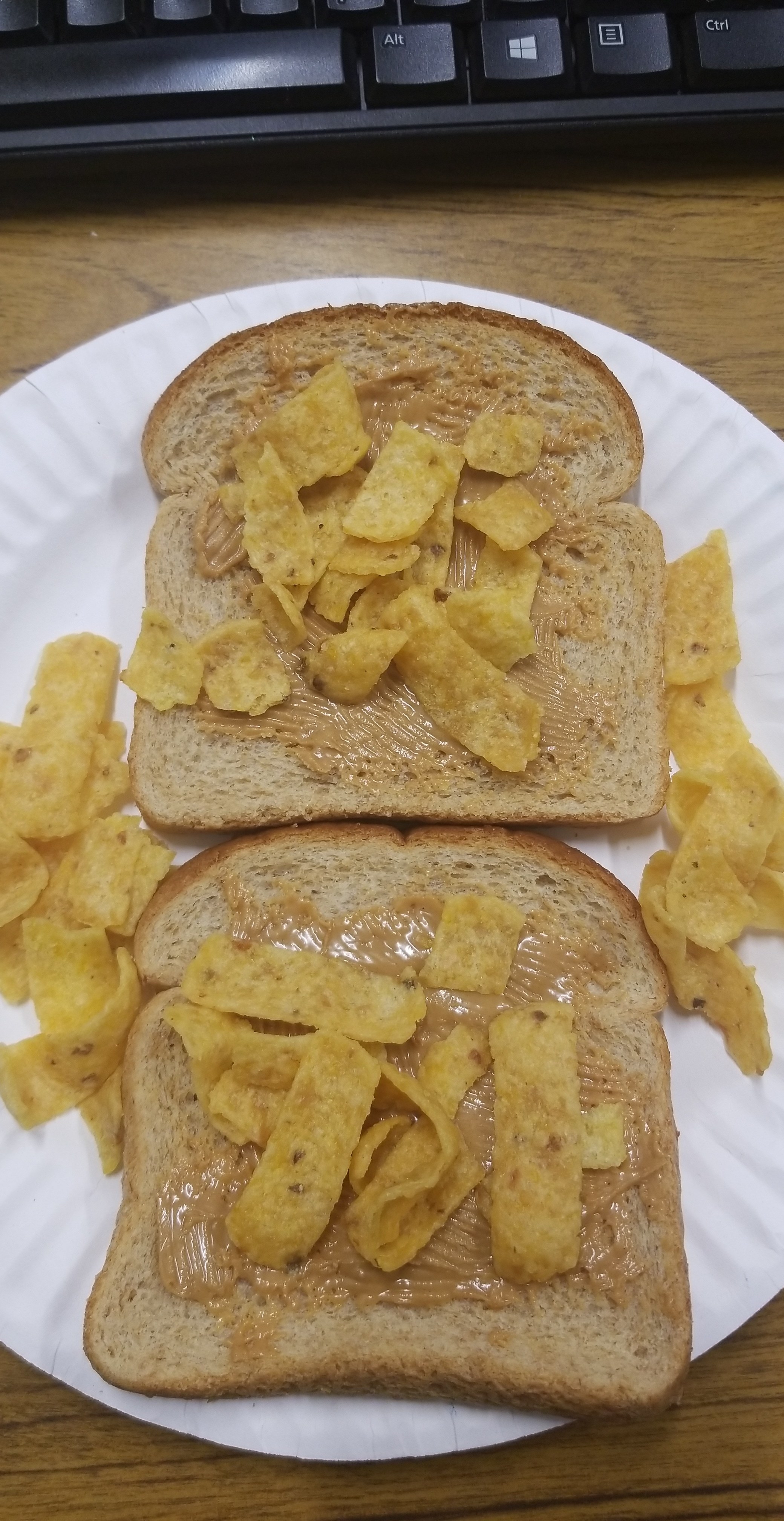 Peanut butter on bread with Fritos.