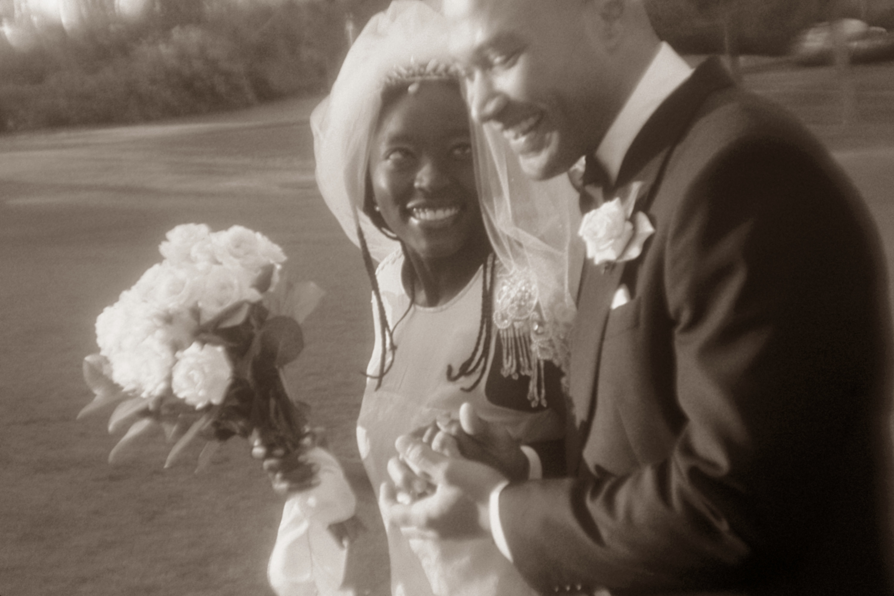 a black and white photo of a couple on their wedding day