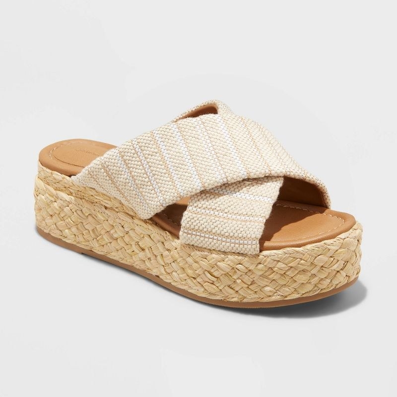 A pair of brown, tan and white sandals