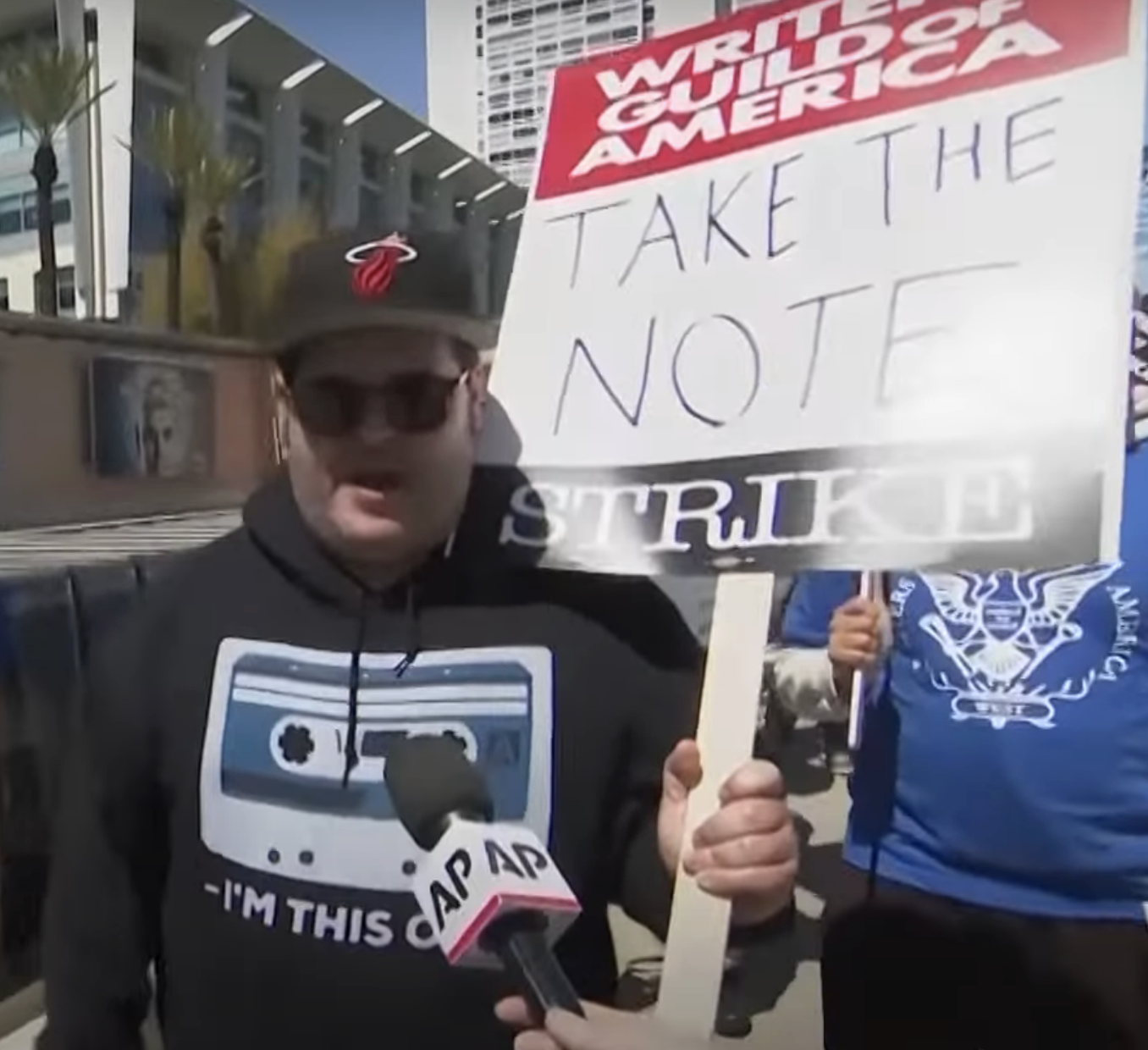 Josh Gad being interviewed while protesting