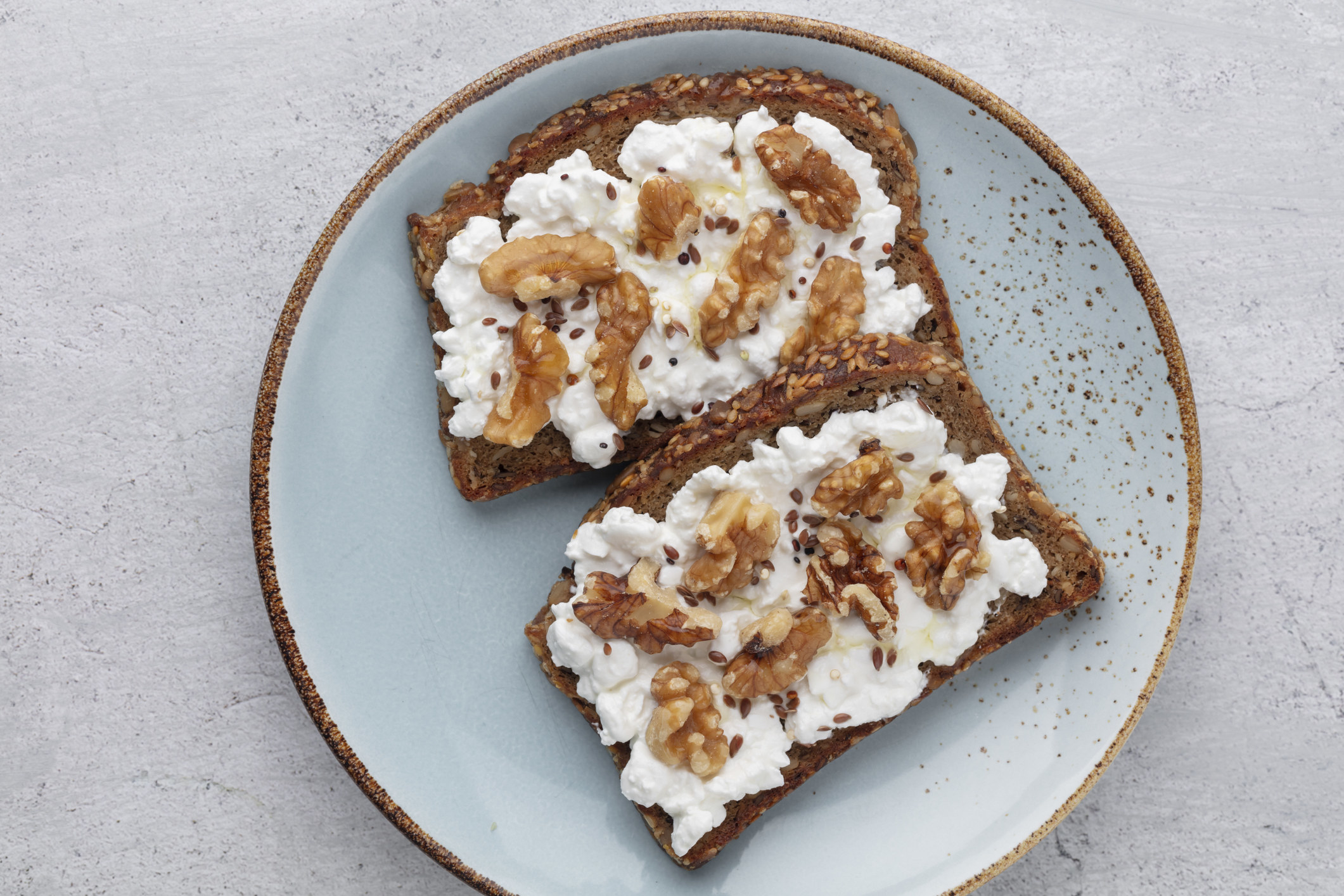 Bread with cream cheese and walnuts.