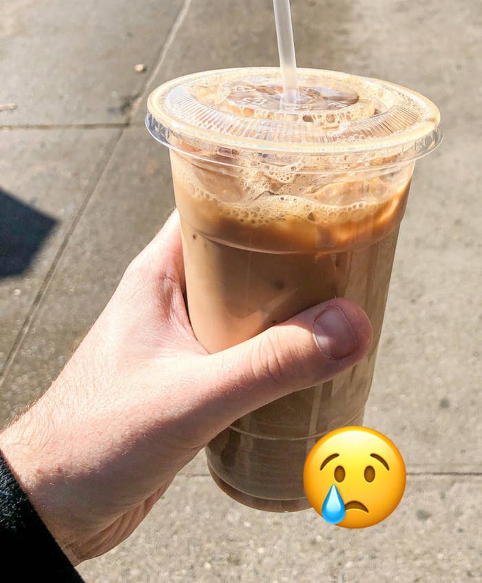 Author holding up iced coffee in plastic cup with text &quot;this cost $7, and let&#x27;s be real, it&#x27;s mostly ice&quot;