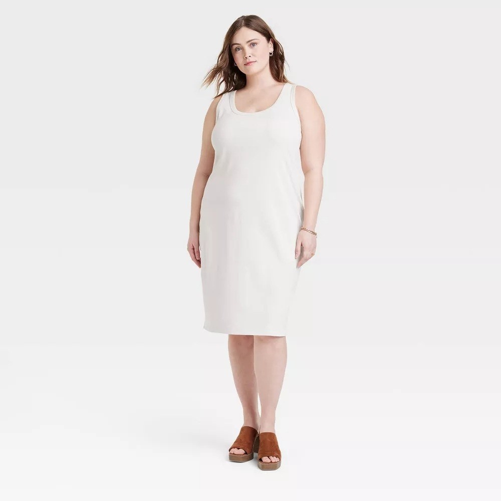 a model wearing the dress in cream