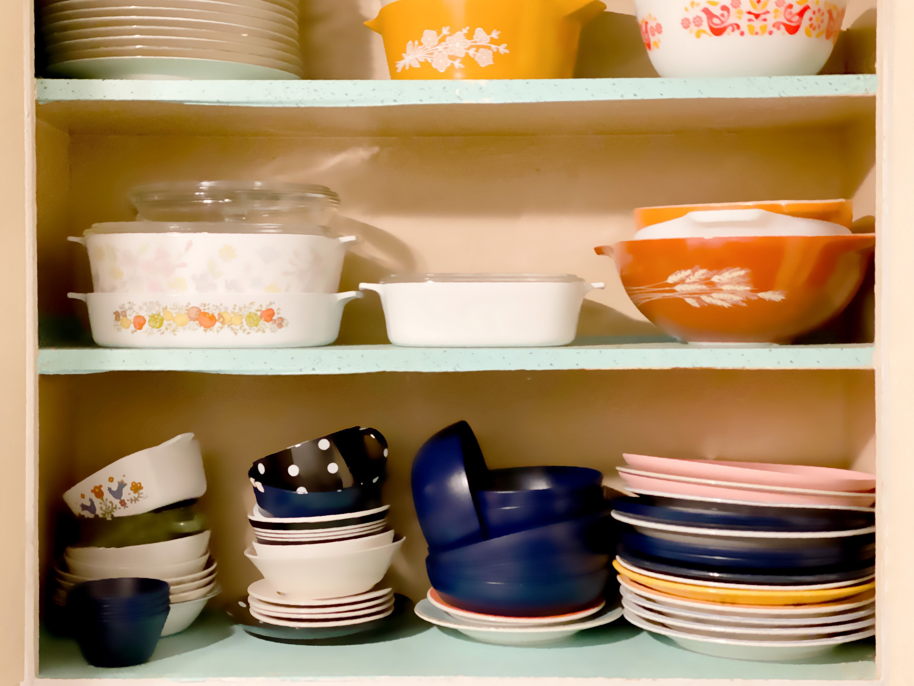 cupboard full of vintage dishes and cookware