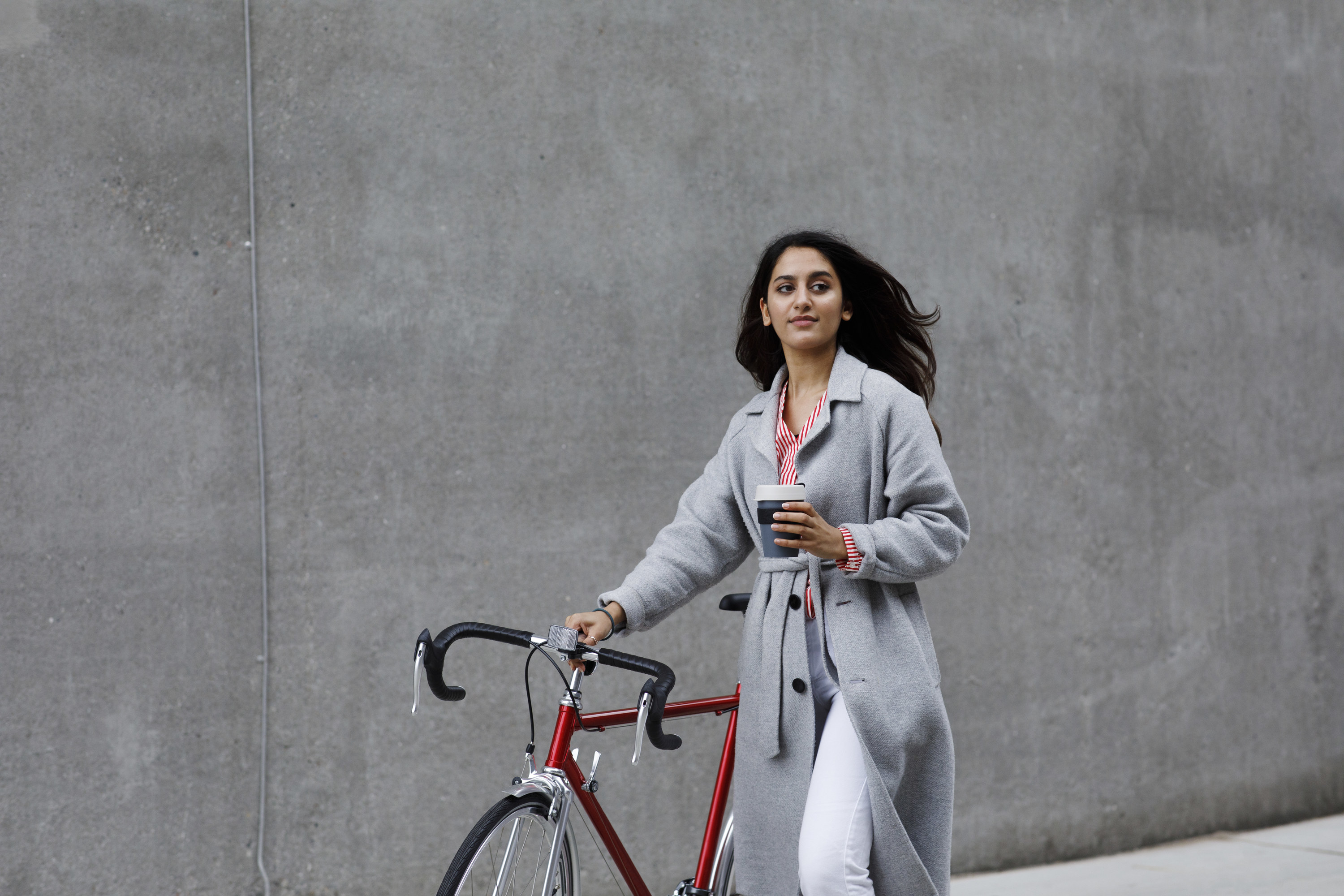 woman pushing her bike in the city