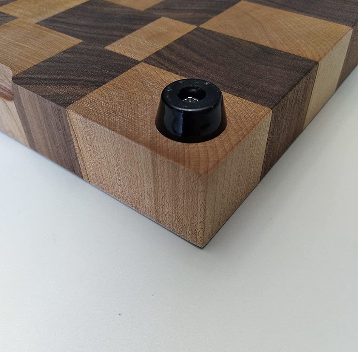 Reviewer image of the rubber feet on a wood cutting board