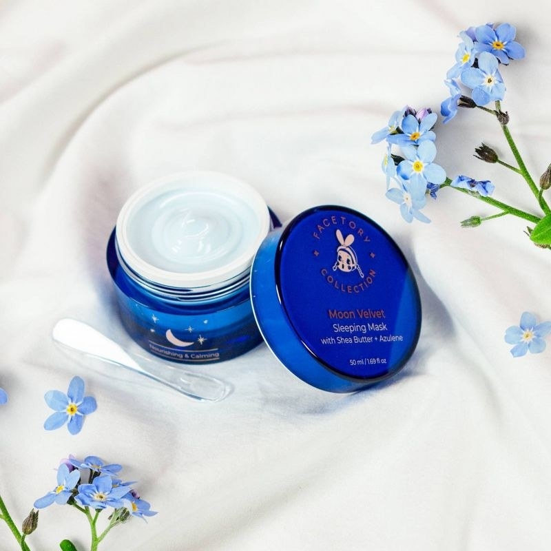 An opened jar of sleeping cream with blue florals