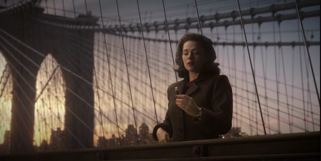 Agent Peggy Carter from &quot;Agent Carter&quot; standing on the side of the Brooklyn Bridge with a vial of liquid