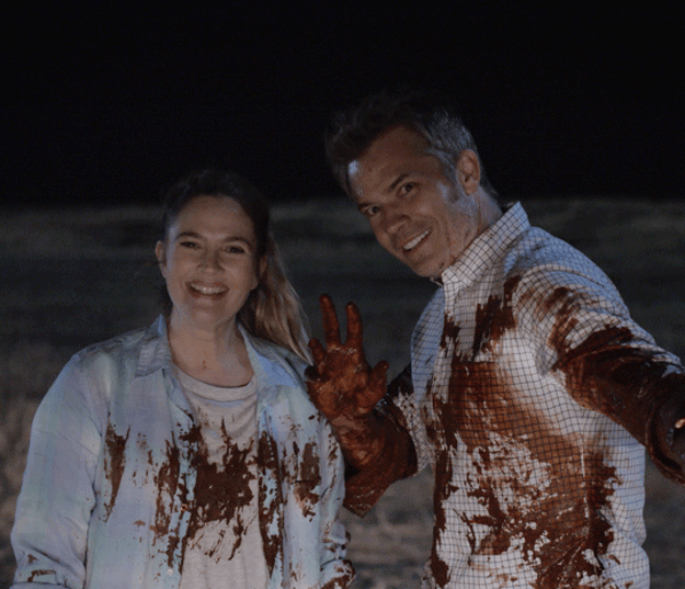 Joel and Sheila from &quot;Santa Clarita Diet&quot; smiling and covered in blood