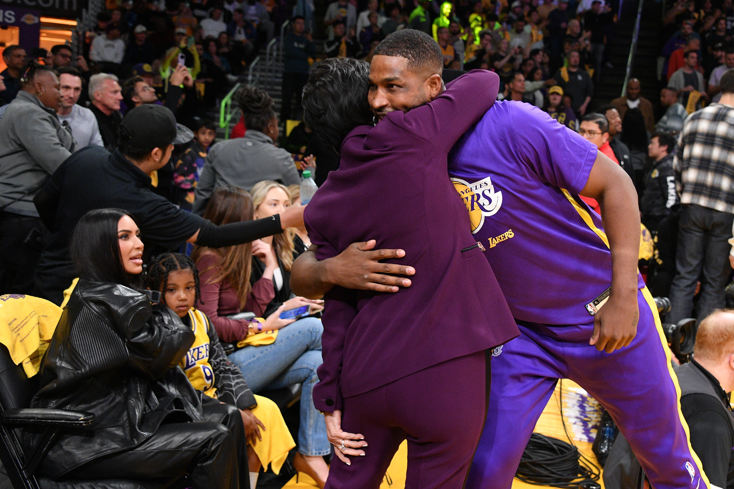 kris and tristan hugging courtside