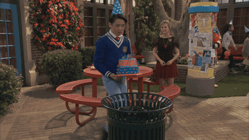 a birthday boy throw a cake in the trash