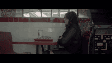 girl eats alone at a restaurant booth