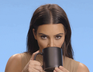 kim drinking from a mug