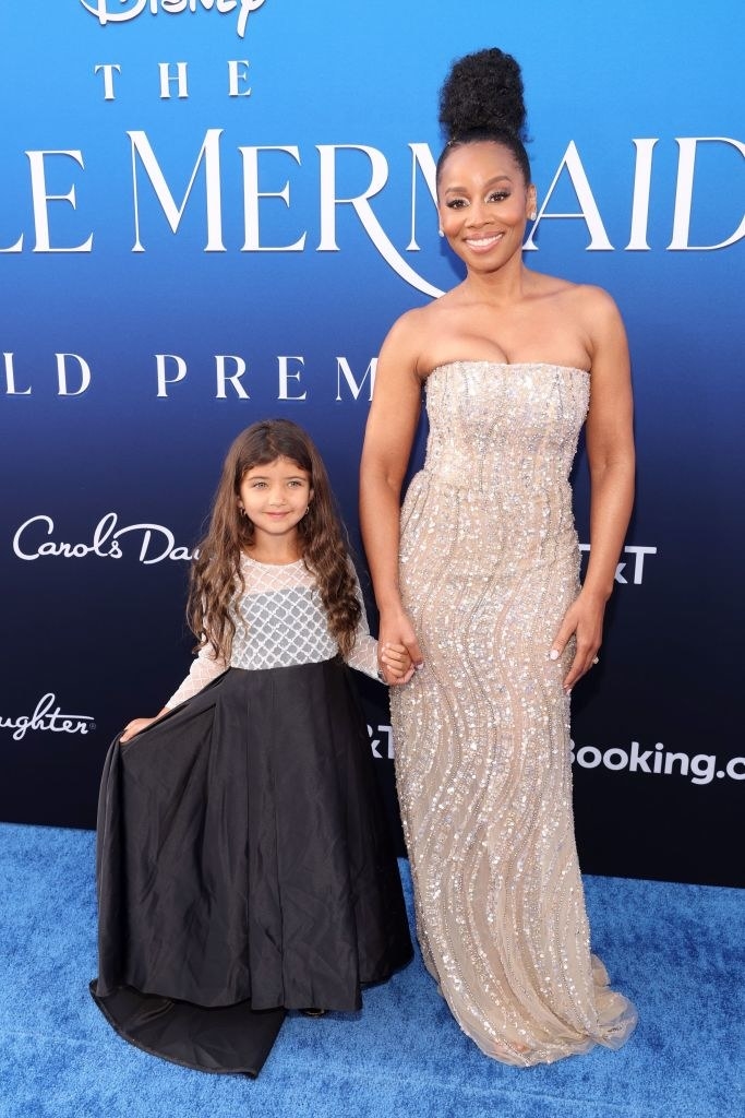 Anika Noni Rose with a little girl on the red carpet