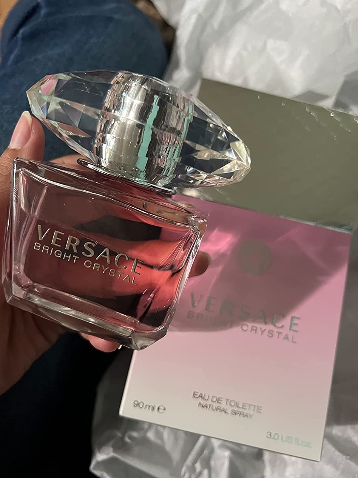 A pink and crystal perfume in a reviewer&#x27;s hand