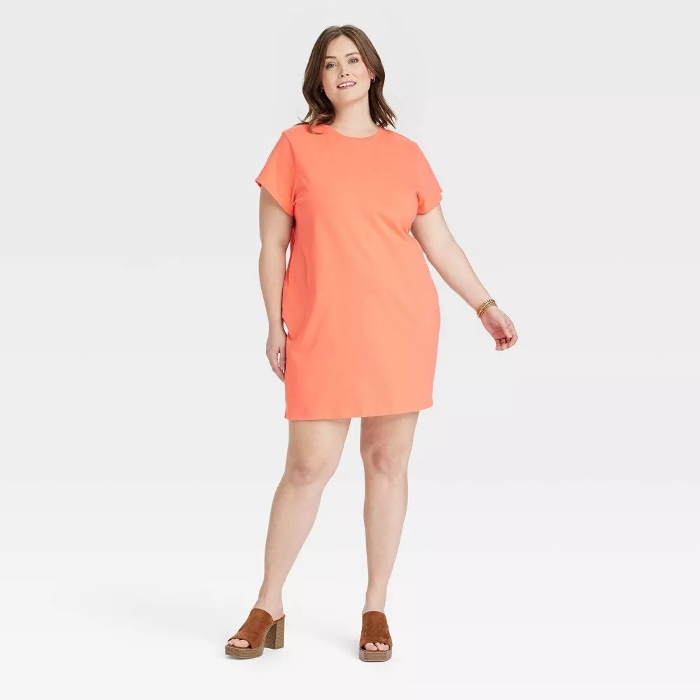 Model wearing the orange dress